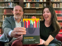 Josh Clark and Veronika Kindred holding a copy of Sentient Design