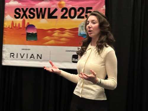 Photo of Veronika Kindred speaking in front of a SXSW banner.